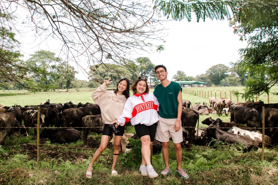 A family standing together in a green farm field